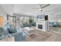 Cozy living room with an electric fireplace and comfortable seating with view of tropical landscaping at 6400 46Th N Ave # 203, Kenneth City, FL 33709