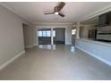 Open-concept living room showcases polished floors with views of the kitchen and ample natural light at 6407 1St Palm Pt, St Pete Beach, FL 33706