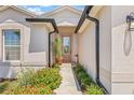 Home featuring a charming entryway, complete with beautiful landscaping and a well-lit porch at 6741 51St N Way, Pinellas Park, FL 33781