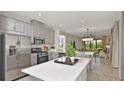 Modern kitchen with stainless steel appliances, white countertops, and a center island at 721 Steel Dr, Apollo Beach, FL 33572
