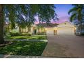 Inviting home showcasing a three car garage, manicured lawn, and mature trees in a desirable neighborhood at 7246 Bucks Ford Dr, Riverview, FL 33578