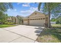 Spacious home featuring a three car garage, neutral color palette, and a well maintained driveway at 7246 Bucks Ford Dr, Riverview, FL 33578