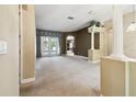 Open living room with neutral paint, carpet, and a view of the outdoor space at 7246 Bucks Ford Dr, Riverview, FL 33578