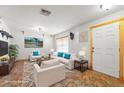 Bright, staged living room featuring neutral furniture and a decorative rug at 7703 N Branch Ave, Tampa, FL 33604