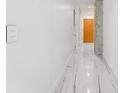 Hallway with white walls, a light switch and marble floors that lead to apartments at 777 N Ashley Dr # 1506, Tampa, FL 33602