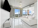 Bright living room with modern fixtures, a balcony, and a beautiful view of the city at 777 N Ashley Dr # 1506, Tampa, FL 33602