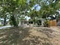Charming single-story home featuring beautiful landscaping and mature shade trees at 7831 Fox Hollow Dr, Port Richey, FL 34668