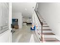 Inviting foyer with a view to the living area and staircase with wood treads at 7911 N Packwood Ave, Tampa, FL 33604
