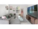 Comfortable living room featuring a modern couch, stylish decor, and natural light at 7911 N Packwood Ave, Tampa, FL 33604