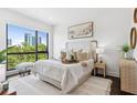 Bright bedroom with a large window showcasing city views, neutral tones, and stylish furnishings at 820 2Nd N Ave, St Petersburg, FL 33701
