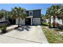 Two-story home with a well-manicured front yard, palm trees, and a convenient two-car garage at 821 Lucent Sands Ct, Brandon, FL 33511