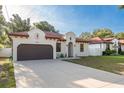 Inviting home with a two-car garage, stucco facade, and well-kept lawn at 8523 N Newport Ave, Tampa, FL 33604