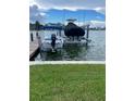 Features private boat lift with a boat, along with a second boat covered, providing convenience for water enthusiasts at 861 180Th E Ave, Redington Shores, FL 33708