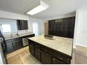 Well-lit kitchen featuring an island and dark cabinetry providing ample storage space at 8665 55Th N St, Pinellas Park, FL 33782