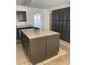 Spacious kitchen island with tile countertop and dark cabinetry, ideal for meal preparation and storage at 8665 55Th N St, Pinellas Park, FL 33782