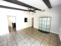 Bright living room featuring tile floors, exposed beams, and ample space for entertaining guests at 8665 55Th N St, Pinellas Park, FL 33782