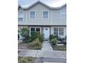 Traditional townhouse showcasing a tidy front yard and a welcoming entrance at 8708 Cobbler Pl, Tampa, FL 33615