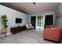 A sunlit living room showcasing hardwood floors, modern furniture, and stylish decor at 10325 Parkcrest Dr, Tampa, FL 33624