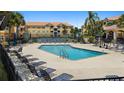 Community pool with plenty of seating for residents at 10764 70Th Ave # 3206, Seminole, FL 33772