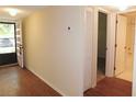 Entryway with hardwood floors and neutral walls leading to the bathroom and other rooms in the condo at 111 Lakeview Pl, Oldsmar, FL 34677