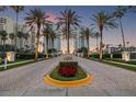 Elegant entrance with palm trees and lush landscaping leading to the Grande, creating a welcoming view at 1180 Gulf Blvd # 402, Clearwater Beach, FL 33767