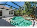 Gorgeous screened-in pool with attached jacuzzi tub and beautiful stone accents at 11938 Royce Waterford Cir, Tampa, FL 33626