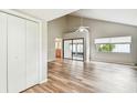 Bright living room with wood floors, vaulted ceilings, and access to the screened porch at 13501 Palmwood Ln # 0, Tampa, FL 33618