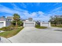 Well-manicured condo community with lush landscaping, long driveways, and attached garages at 13635 Twin Lakes Ln # 13635, Tampa, FL 33618