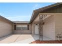 Inviting covered entry featuring a decorative wrought iron support and a freshly painted front door at 1406 Valley Pl, Brandon, FL 33510