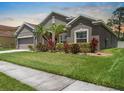 A neatly kept lawn and landscaping surround this home, enhancing its curb appeal and charm at 1517 Yale Castle Ct, Ruskin, FL 33570