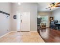 Welcoming foyer with tile flooring and view into the living room with hardwood floors at 1524 Rhodeswell Ln, Dover, FL 33527