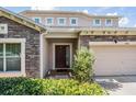 Close up of the front door with stone facade and neatly trimmed shrubbery at 1524 Rhodeswell Ln, Dover, FL 33527