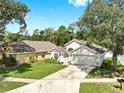 Well-maintained home shows a verdant lawn, a two-car garage, and proximity to neighboring houses at 16928 Hawkridge Rd, Lithia, FL 33547