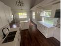 Beautiful kitchen with white cabinets, stainless steel appliances, and hardwood floors at 18127 Us Highway 41, Spring Hill, FL 34610