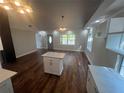 Open concept living space featuring an island, hardwood floors, and natural light at 18127 Us Highway 41, Spring Hill, FL 34610