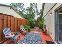 Private outdoor patio area with pavers, wooden fence, and comfortable seating at 1948 Elaine Dr, Clearwater, FL 33760