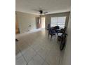 An empty living room features ceramic tile flooring, a ceiling fan, and one window with blinds at 201 Lentz Rd, Brandon, FL 33510