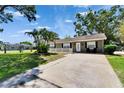 Charming single-story home with front yard, well-maintained lawn, and mature trees at 206 4Th Nw Ave, Ruskin, FL 33570
