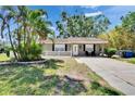 Charming single-story home with front yard, well-maintained lawn, and mature trees at 206 4Th Nw Ave, Ruskin, FL 33570