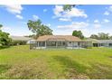 A screened-in pool encloses the back of this single story home at 206 Forest Wood Ct, Spring Hill, FL 34609