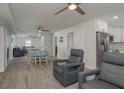 Open-concept living space with modern furniture, ceiling fans, and abundant natural light at 2271 Carolyn Dr, Dunedin, FL 34698