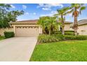 Lovely single-story home with a two-car garage and mature landscaping at 3302 Granite Ridge Loop, Land O Lakes, FL 34638