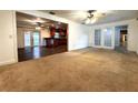 Spacious living room featuring an open floor plan leading to the dining and kitchen areas at 3419 Pearson Rd, Valrico, FL 33596