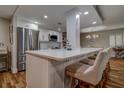 Modern kitchen island with quartz countertops and stainless steel appliances and seating at 36750 Us 19 N # 24-213, Palm Harbor, FL 34684