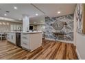 Open-concept kitchen with a large island, modern appliances and decorative wallpaper at 36750 Us 19 N # 24-213, Palm Harbor, FL 34684
