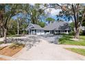 Charming two-story home with mature trees, a long driveway and beautiful landscaping at 4202 Deepwater Ln, Tampa, FL 33615