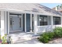 Charming front porch with detailed woodwork, a hanging lantern, and beautiful shrubbery at 4202 Deepwater Ln, Tampa, FL 33615