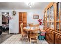 Dining room with wooden table and chairs next to a china cabinet, blending functionality and classic design at 4527 W Minnehaha St, Tampa, FL 33614