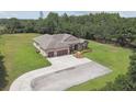 Expansive aerial view of property featuring a large lawn, mature trees and long driveway at 4608 Scott Rd, Lutz, FL 33558