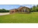 Beautiful home with a lush green lawn and mature landscaping at 4608 Scott Rd, Lutz, FL 33558